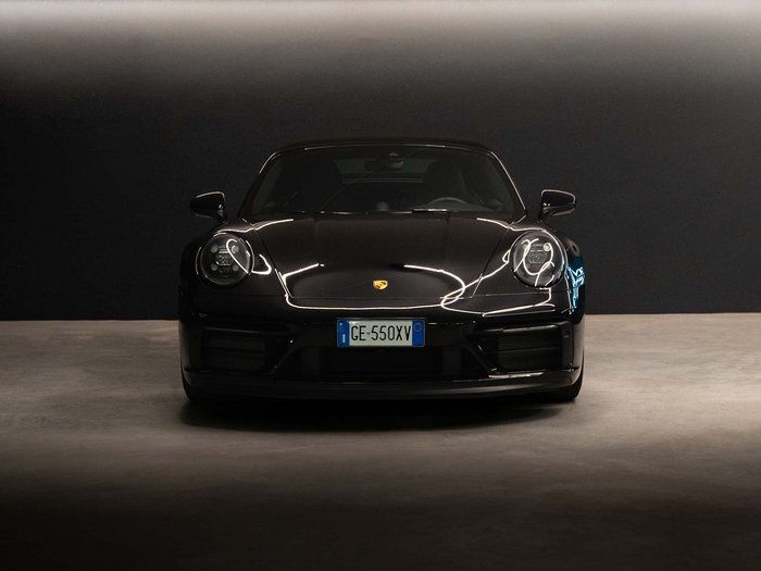 Car rental in Val Pusteria/Pustertal, Dolomites Black Porsche 911 front view in dark room