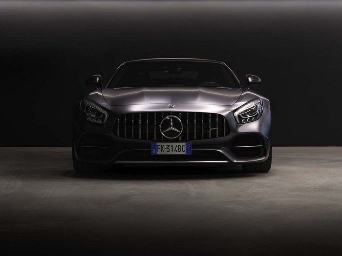 Car rental in Val Pusteria/Pustertal, Dolomites Front view of a black Mercedes-Benz sports car in a dark setting