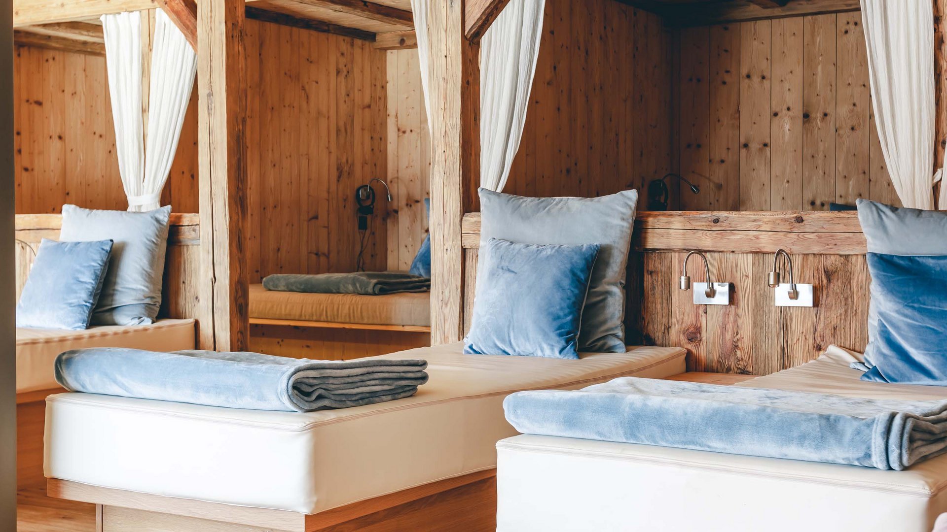 Relax room with wooden design and blue pillows on white loungers