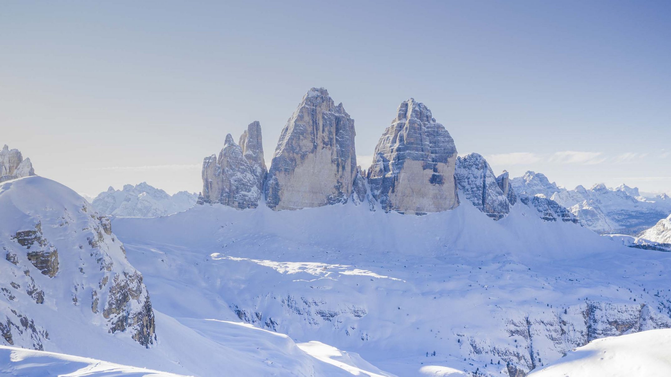 Your 5-star hotel in Val Pusteria/Pustertal: Alpen Tesitin Snow-covered mountains with distinctive peaks under clear blue sky
