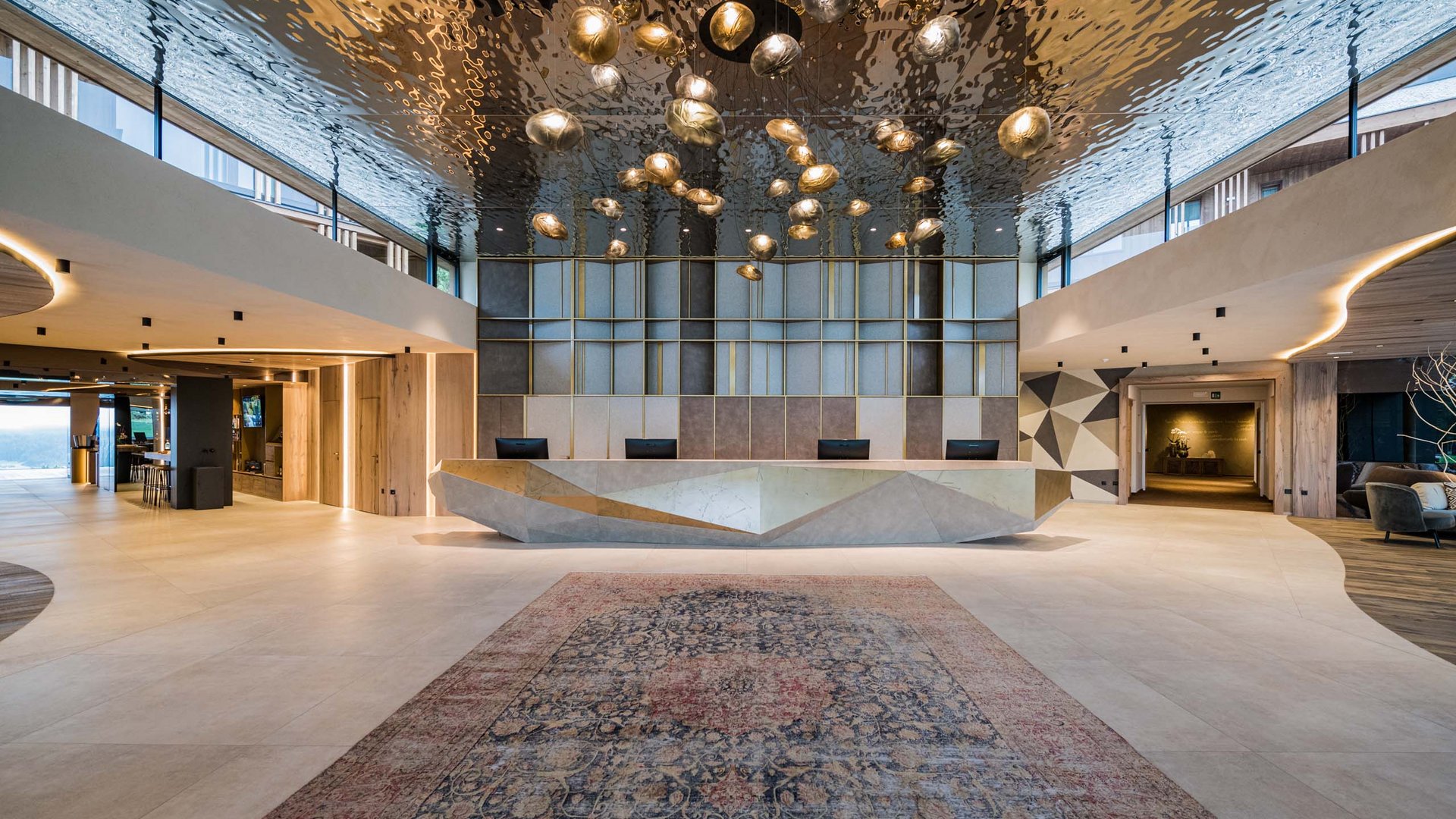 Modern lobby with geometric reception desk and sculptural ceiling lights