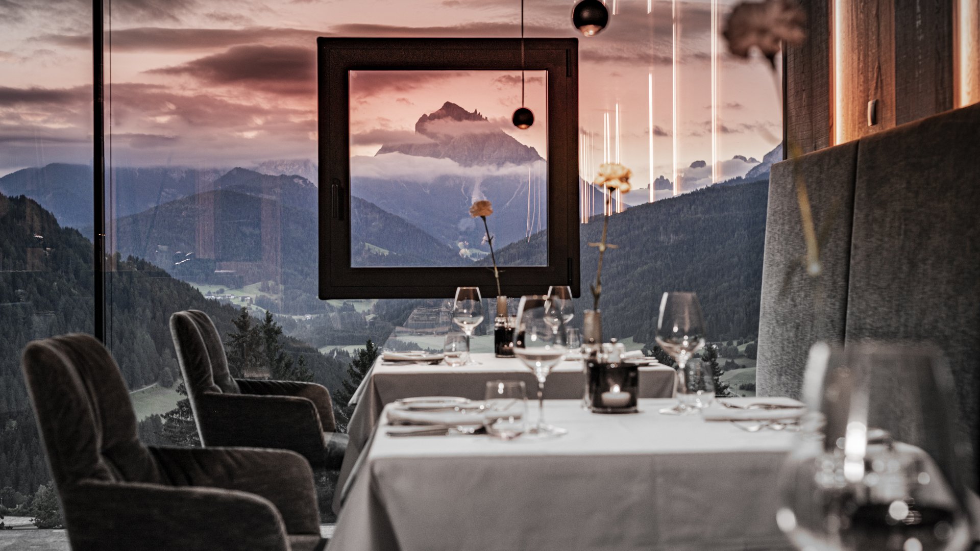 Elegant restaurant with mountain and sunset view through window