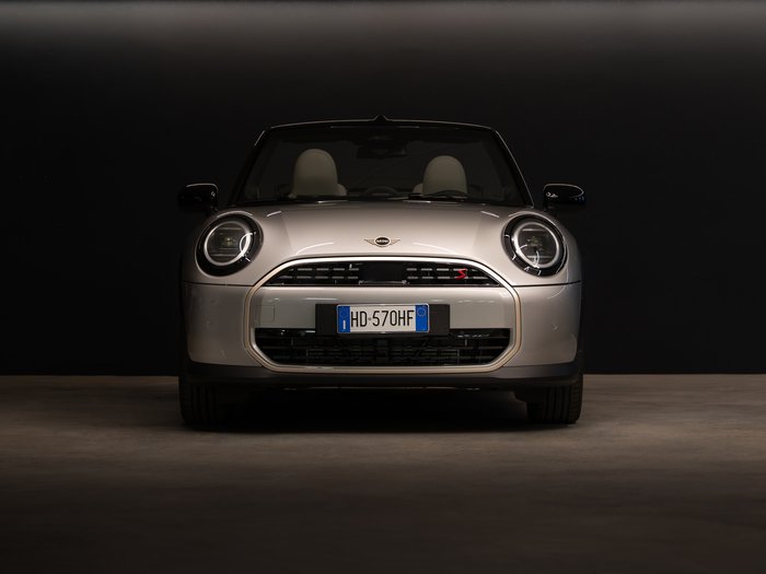 Car rental in Val Pusteria/Pustertal, Dolomites Front view of a silver Mini Cooper against a black background
