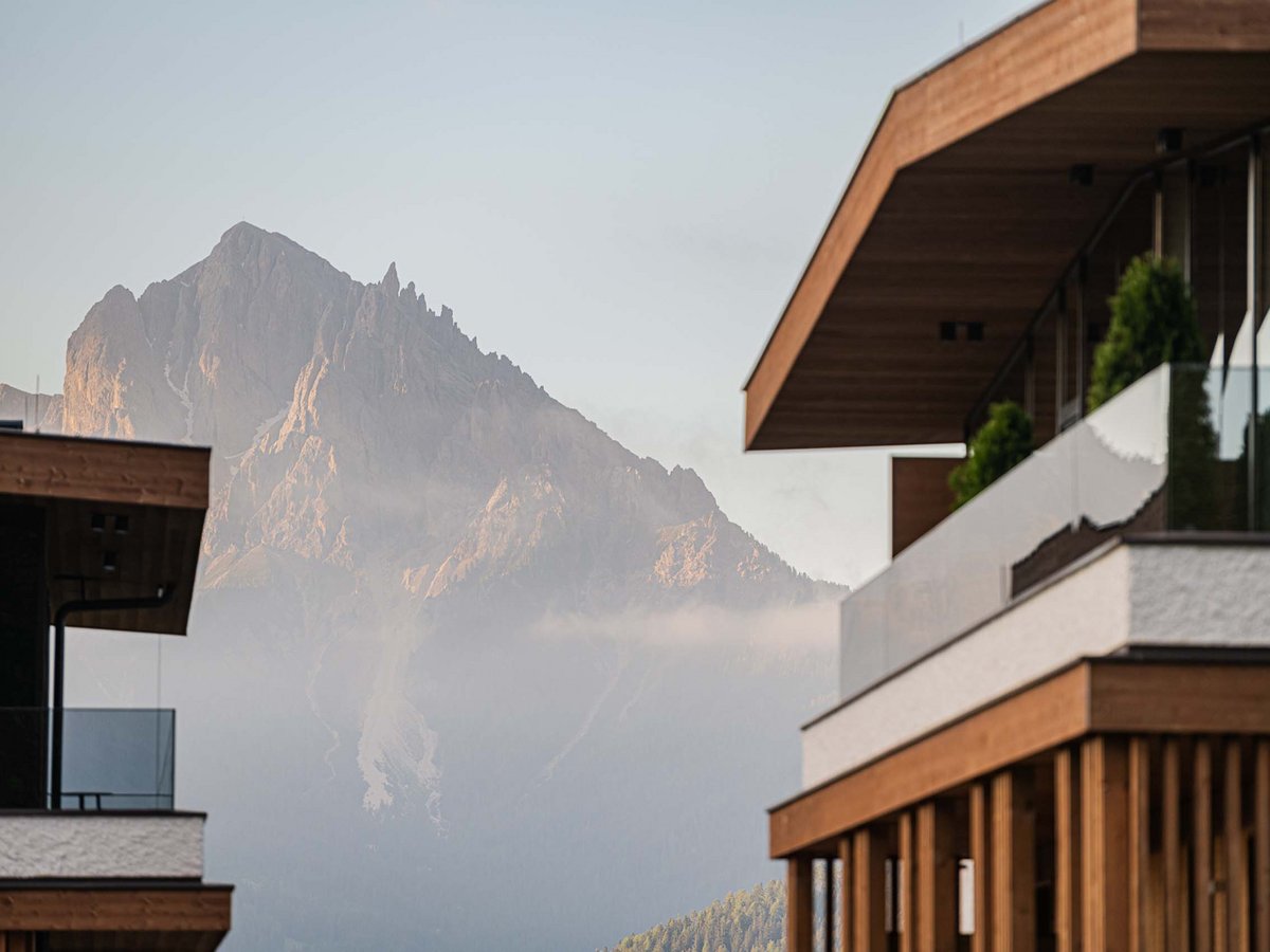 Your 5-star hotel in Val Pusteria/Pustertal: Alpen Tesitin Modern building facade with mountain in the background under clear sky