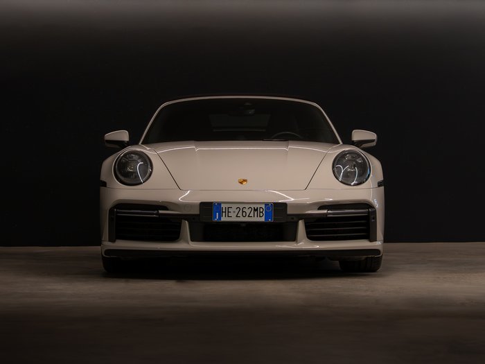 Car rental in Val Pusteria/Pustertal, Dolomites Front view of a white Porsche sports car against a dark background